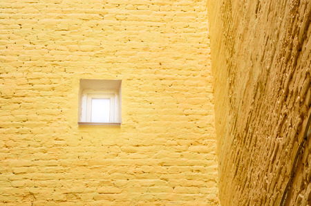 A small window in the brick wall. Corner of the house. Concept minimalismの写真素材