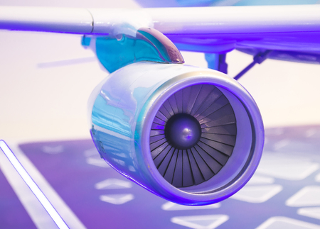 Engine on the wing of the aircraft with a blue backlight