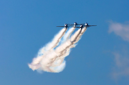 Aerobatic team aircraft fighters trail of smoke in the skyの写真素材