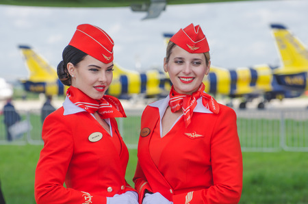 Charming Stewardess Dressed In Red Uniform. Russia, Moscow. July 2017