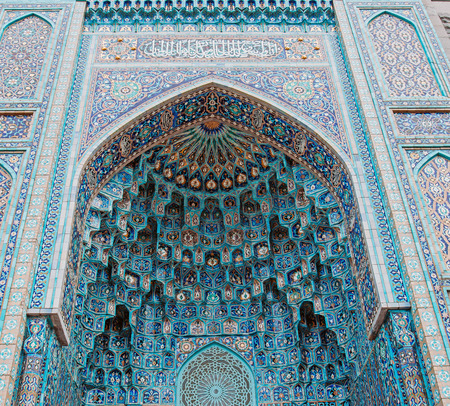 The arch of the mosque in blue tones is made from the mosaic of the Islamic religionの写真素材