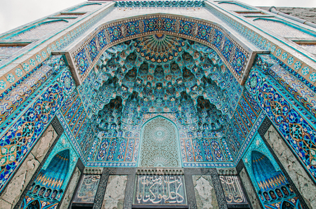 The arch of the mosque in blue tones is made from the mosaic of the Islamic religionの写真素材