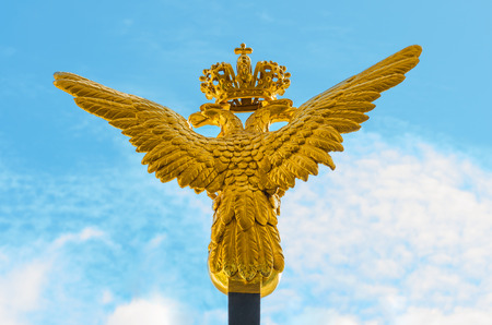two-headed golden eagle on blue sky backgroundの写真素材