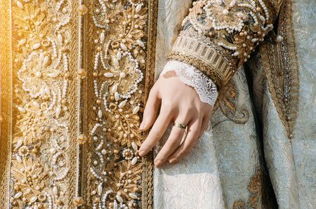 Clothes of a historical imperial woman with pastel tones, a hand with a ring with a precious stoneの写真素材