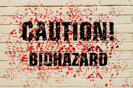 Inscription Caution Biohazard on a bloodstained brick wallの写真素材