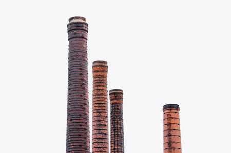 Four tall pipes of red brick, factory chimneyの写真素材
