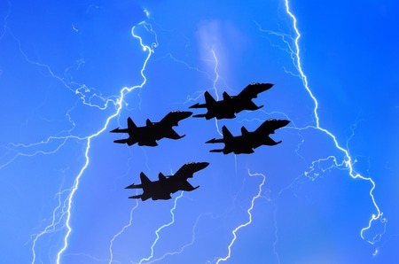 Group of combat fighters jet against the background of lightning thunderstorms weather at night