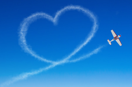 Love figurative heart from a white smoke trail airplaneの写真素材