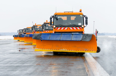 Snowplows in the work on the runway at the airportの写真素材
