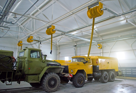 Large old cargo trucks in a hangar garageの写真素材