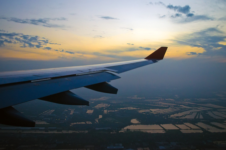 View of the sunset,clouds and airplane wing from the Insideの写真素材