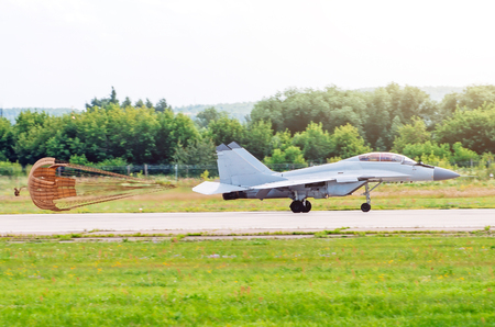 Combat fighter after landing on the runway with the released parachuteの写真素材
