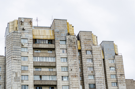 Old multi-storey houses, with holes in concreteの写真素材