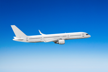 Passenger white airplane on the side view, flies on a flight level skyの写真素材