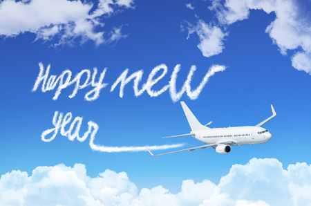 Happy New year concept. Drawing by airplane vapor contrail in skyの写真素材