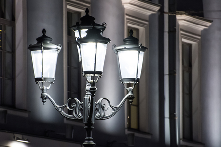 Vintage street lights at night with patterned decorationsの写真素材