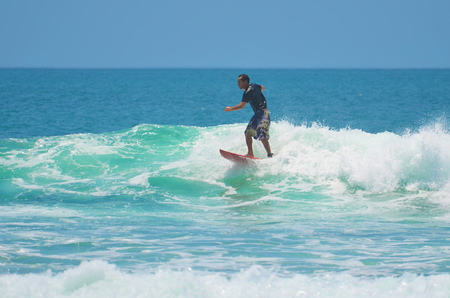 Surfer in green blue in the ocean wave, surfing. Indonesia, Bali, 10 November 2011のeditorial素材
