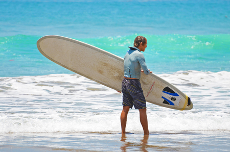 Surfer in green blue in the ocean wave, surfing. Indonesia, Bali, 10 November 2011のeditorial素材