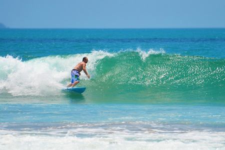 Surfer in green blue in the ocean wave, surfing. Indonesia, Bali, 10 November 2011のeditorial素材