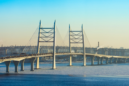 Cable-stayed bridge high-speed highway across the river in winterの写真素材