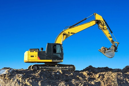 Excavator work on the ground on background blue skyの写真素材