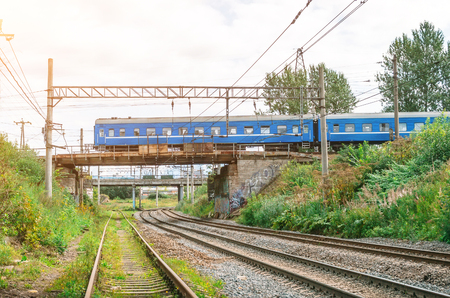 Train a passenger car drives along a railroad bridge through a friend railwayの写真素材