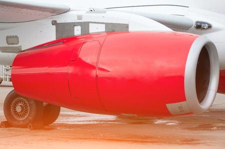 View of the wing and red engine of the aircraft repair in the hangarの写真素材