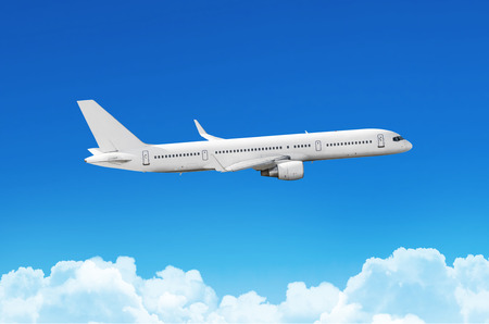 Passenger plane fly on a train above clouds and blue skyの写真素材