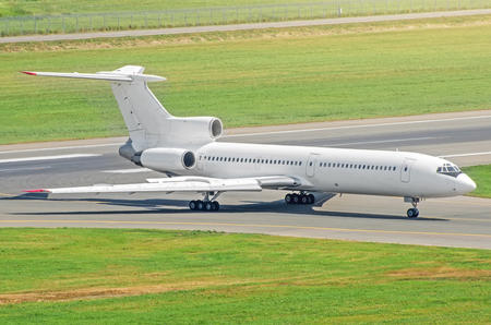Airplane on the taxing track left the airport view from aboveの写真素材