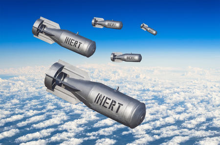 Falling bombs weapons charges dropped from a fighter combat aircraft high in the sky, a view of clouds and landの写真素材