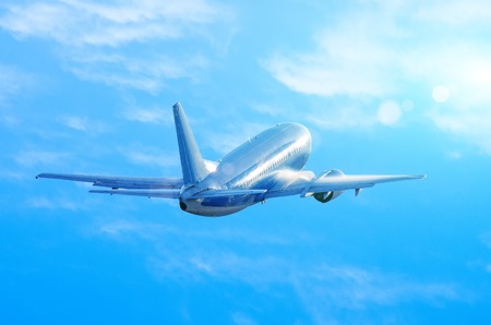 Airplane take off in wet, damp weather, the water flows down the fuselage when climbing blue sky cloudsの写真素材