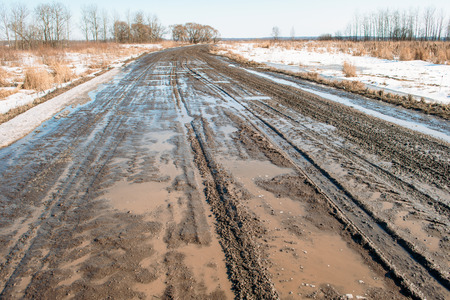 Dirty road in spring water snow springの写真素材