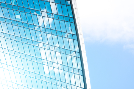 Reflection of sky and clouds in glass windows of financial skyscrapersの写真素材