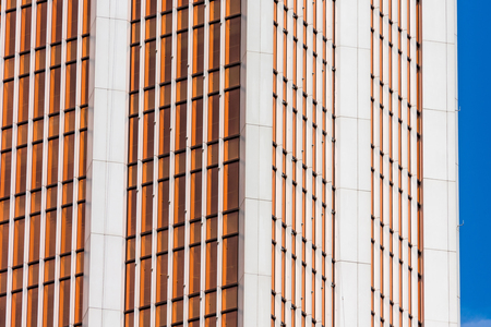 Angle glass red, burgundy, brown facades of a window of financial skyscrapers, a corner of a building close-upの写真素材