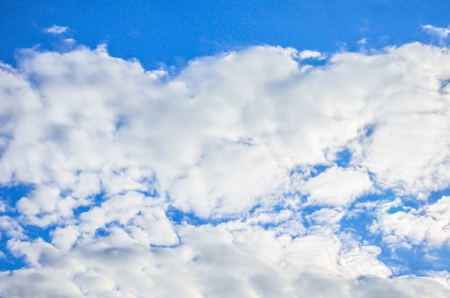Blue sky with white summer alto cumulus cloudsの写真素材