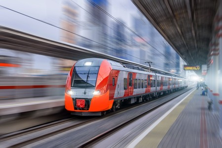 High speed train rides at high speed at the railway station in the cityの写真素材