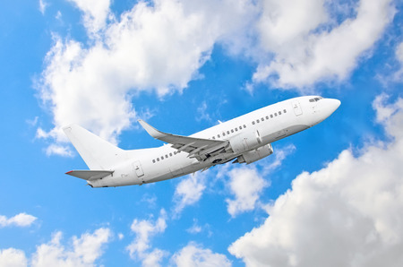 Passenger airplane fly on a hight above overcast clouds and blue skyの写真素材