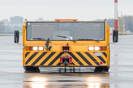 Aerodrome tow tractor is driving along the steering paths at the airportの写真素材