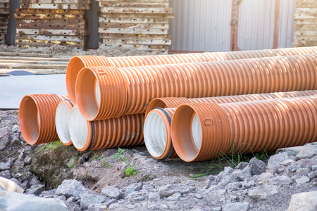 Pipes plastic corrugation large diameter red and orange for constructionの写真素材