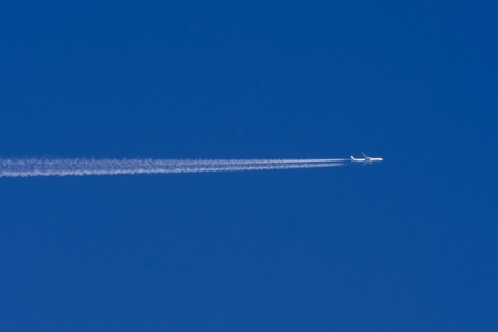 White aircraft big two engines aviation airport contrail cloudsの写真素材