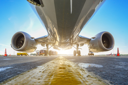 Airplane in the parking lot of the airport apron, bottom view hdr of engines, fuselage and wingsの写真素材