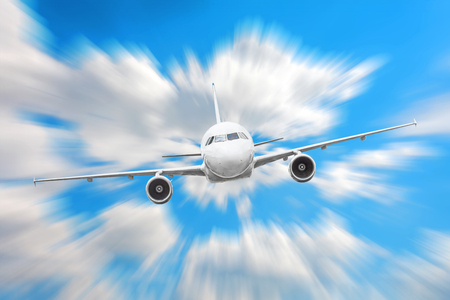 Airplane in the sky above the clouds flight journey sun height speed motion blurの写真素材