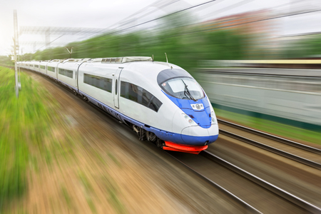 High speed train rides at high speed at the railway station in the cityの写真素材
