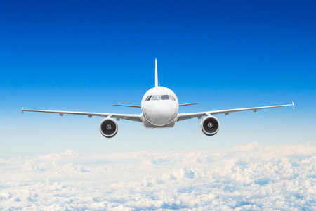 Airplane in the sky above the clouds flight journey sun height.の写真素材
