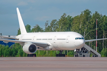 Commercial passenger airplane in the parking at the airportの写真素材