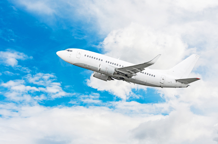 Passenger airplane flying travel, trip at flight level over the white cloudsの写真素材