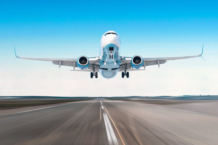 Airplane flying departure landing speed motion on a runway in the clear sky bright dayの写真素材