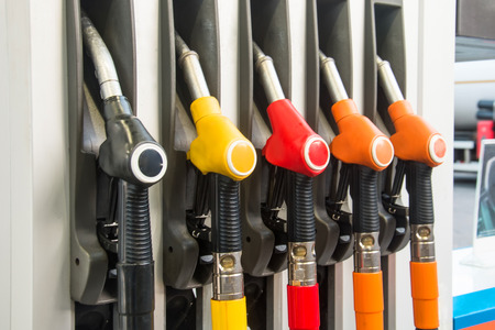 Colorful Petrol pump filling nozzles, refueling gas stations in a serviceの写真素材
