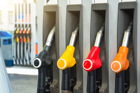 Colorful petrol pistols pump filling nozzles, refueling gas stations in a serviceの写真素材