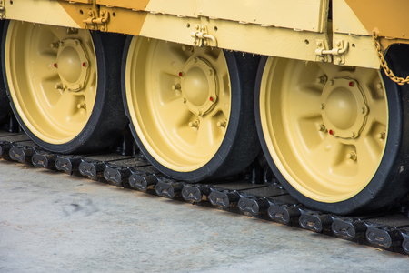 Caterpillar wheels of a tank of yellow colour close-upの写真素材